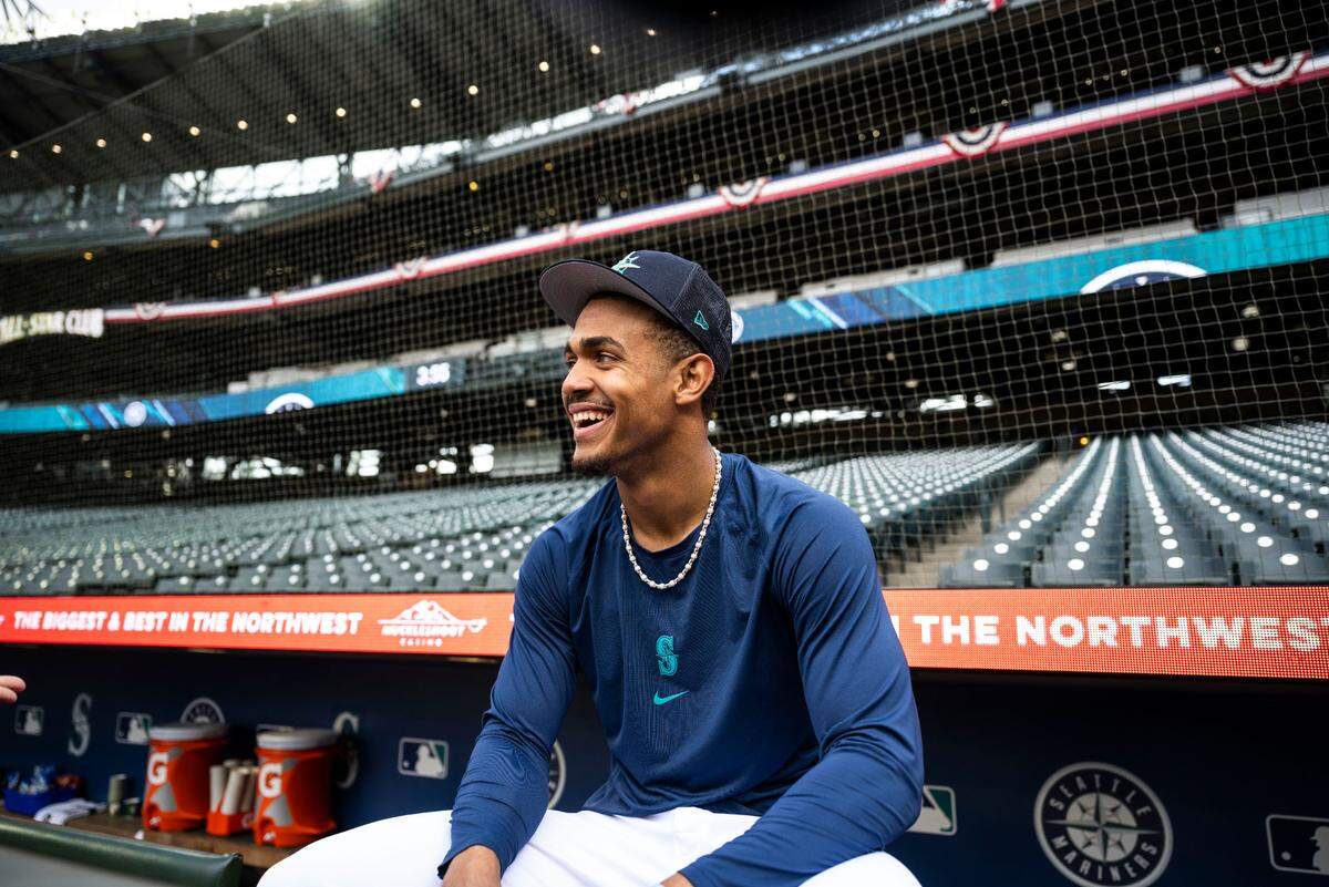 Seattle Mariners center fielder Julio Rodriguez (44) sits behind the dugout before the start of the Mariners home opener against the Cleveland Guardians at T-Mobile Park in Seattle on Thursday, March 30, 2023.