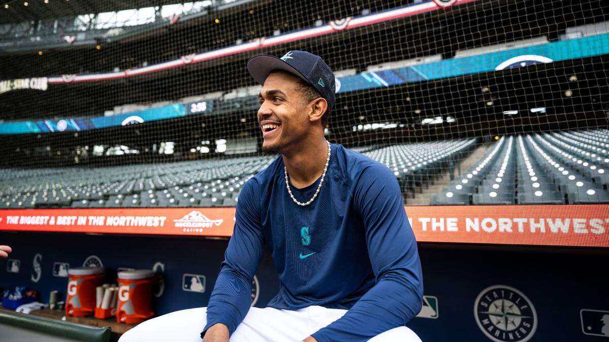 Seattle Mariners center fielder Julio Rodriguez (44) sits behind the dugout before the start of the Mariners home opener against the Cleveland Guardians at T-Mobile Park in Seattle on Thursday, March 30, 2023.
