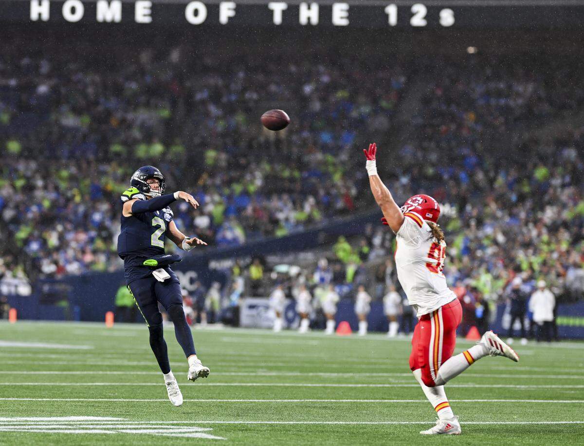 Seattle Seahawks quarterback Drew Lock (2) throws under pressure from Kansas City Chiefs defensive tackle Marlon Tuipulotu (92) during the second quarter of the preseason game at Lumen Field, on Friday, Aug. 15, 2025, in Seattle.