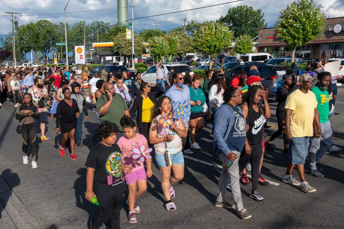 Kelsey Ussery, center-right, grieves as she is followed by hundreds of people during a peace walk in the memory of Ussery’s daughter, Iyana, on Thursday, July 7, 2022, in Tacoma, Wash. Iyana Ussery was shot and killed on Wednesday, July 6, 2022.