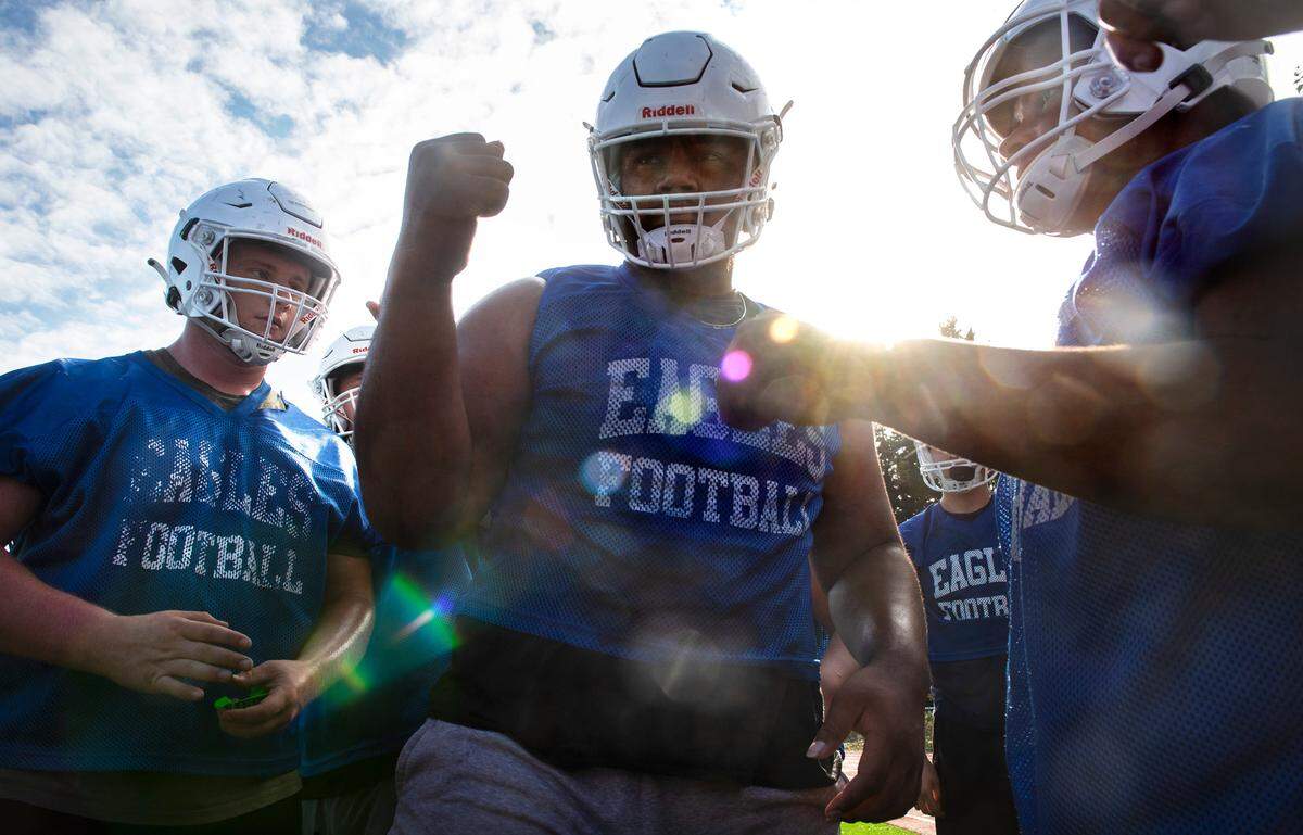 Graham-Kapowsin lineman Vega Ioane rallies the Eagles during football practice at Graham-Kapowsin High School in Graham, Washington, on Wednesday, Aug. 18, 2021.