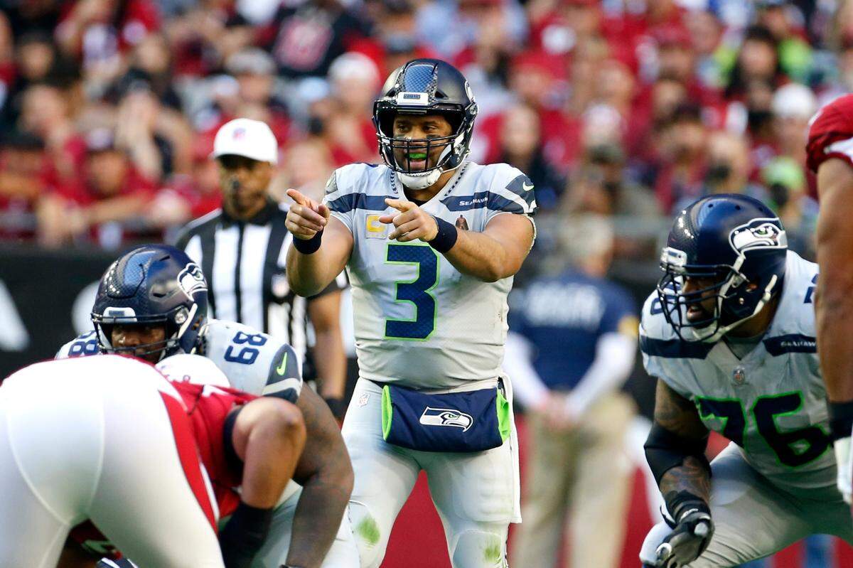 Seattle Seahawks quarterback Russell Wilson (3) shouts instructions as Seahawks offensive tackle Duane Brown (76) looks on during the first half of an NFL football game against the Arizona Cardinals Sunday, Jan. 9, 2022, in Glendale, Ariz. (AP Photo/Ralph Freso)