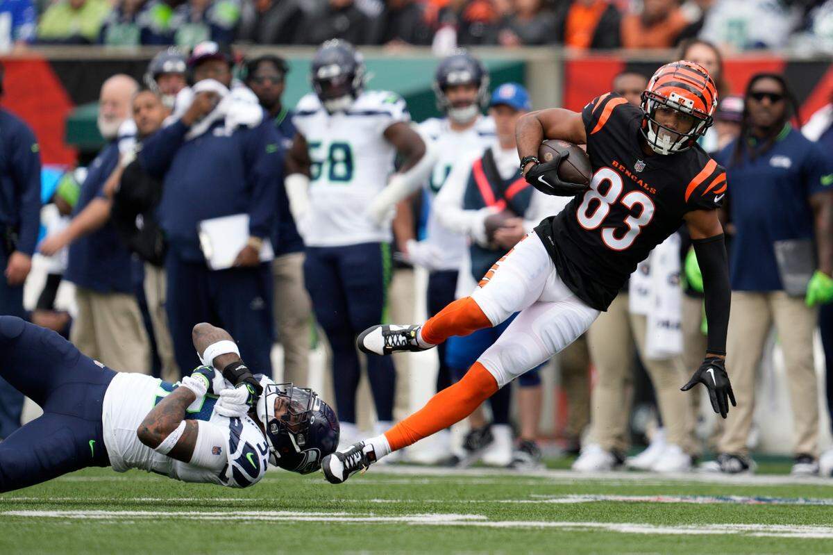 Cincinnati Bengals’ Tyler Boyd (83) is tackled by Seattle Seahawks’ Jamal Adams during the first half of an NFL football game, Sunday, Oct. 15, 2023, in Cincinnati. (AP Photo/Jeff Dean)
