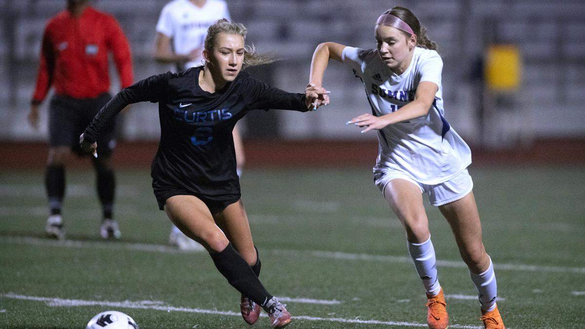 Curtis defender Ivy Korbal (left) battles Sumner midfielder Ava Morton for control of the ball during Monday night’s girls soccer game at Viking Stadium in University Place, Washington, on Oct. 9, 2023. Curtis won the game, 3-2.