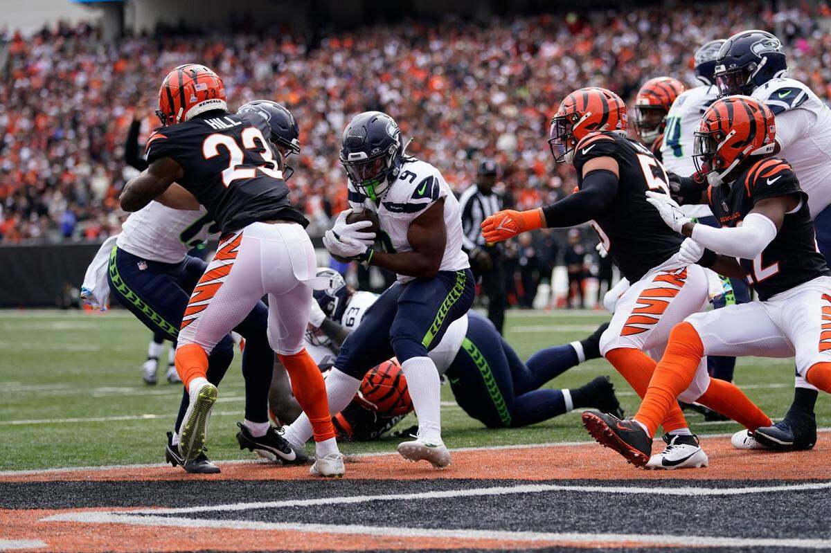 Seattle Seahawks running back Kenneth Walker III (9) goes in for a touchdown during the first half of an NFL football game against the Cincinnati Bengals, Sunday, Oct. 15, 2023, in Cincinnati. (AP Photo/Carolyn Kaster)