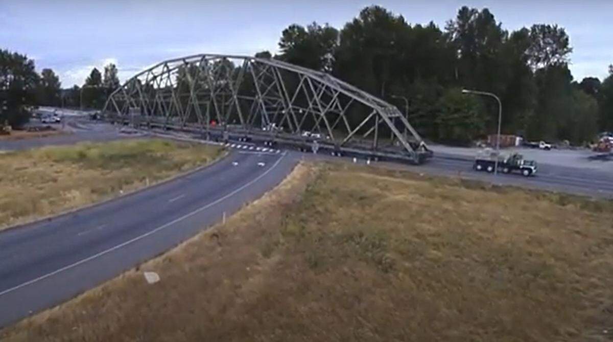 Crews slowly pull the Puyallup River Bridge up North Meridian Avenue to its final resting spot near SR 167 in August 2016.