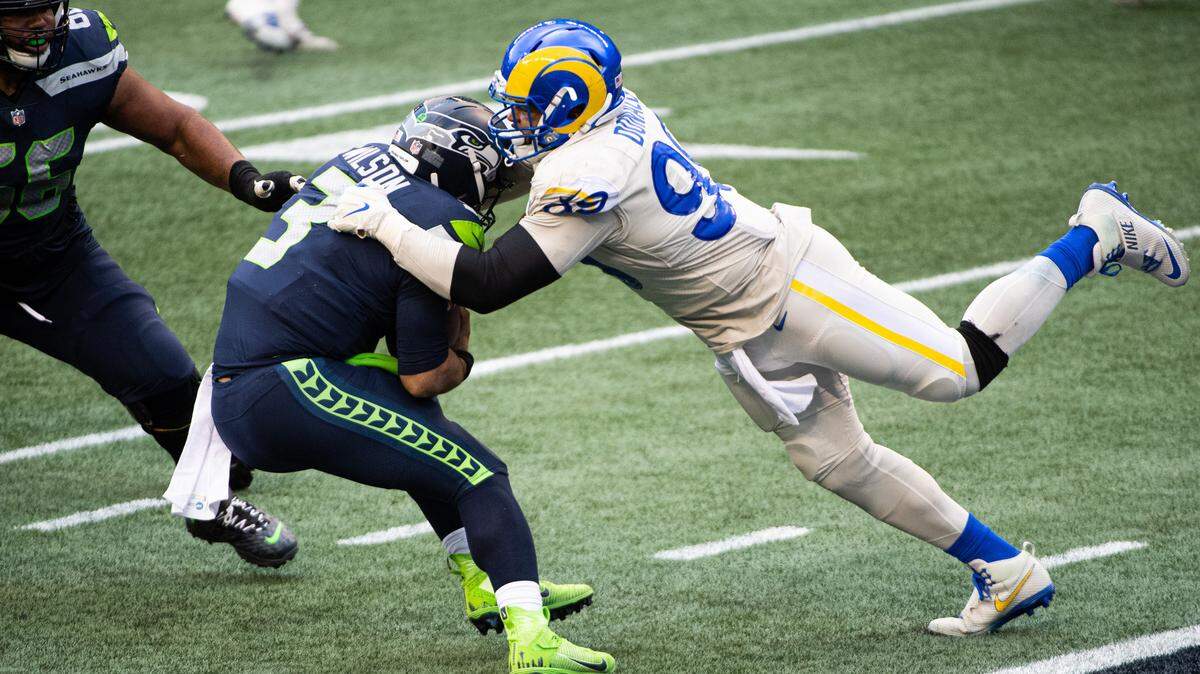 Los Angeles Rams defensive end Aaron Donald sacks Seattle Seahawks quarterback Russell Wilson during the third quarter. The Seattle Seahawks played the Los Angeles Rams in a NFL football game at Lumen Field in Seattle, Wash., on Sunday, Dec. 27, 2020.