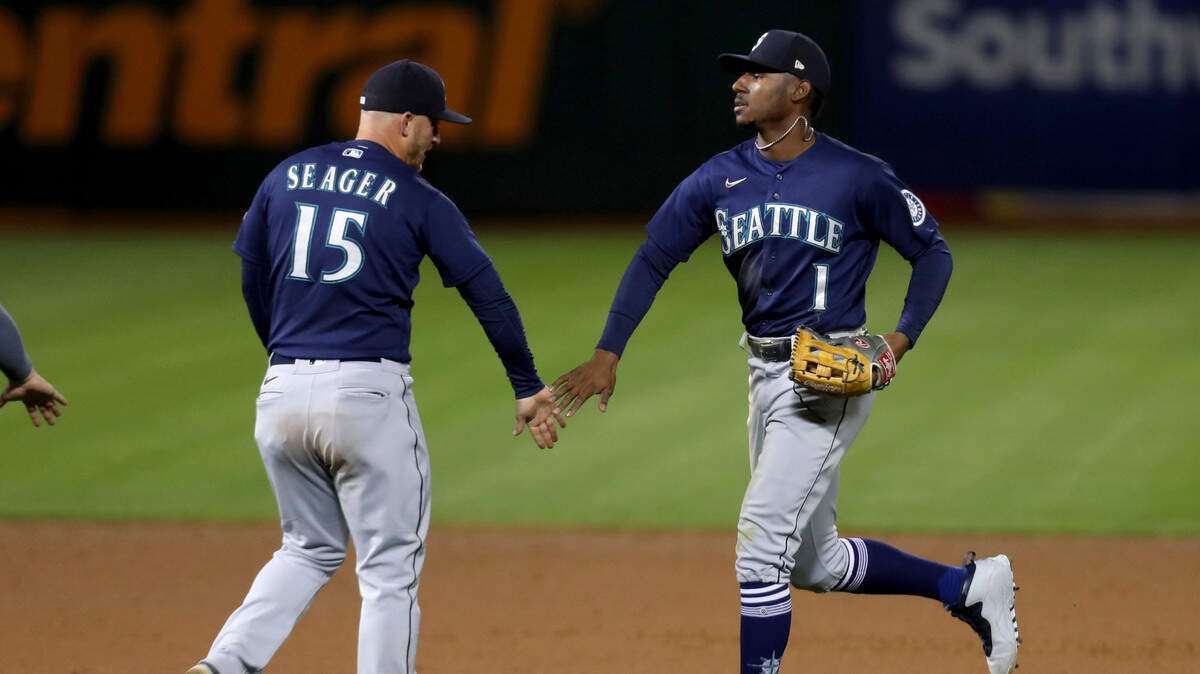 Seattle Mariners’ Kyle Lewis is congratulated by teammate Kyle Seager after defeating the Oakland Athletics during a baseball game in Oakland, Calif., Monday, May 24, 2021. (AP Photo/Jed Jacobsohn)