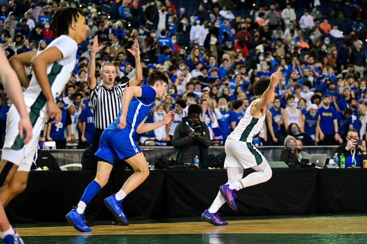Auburn guard Maleek Arington (3) celebrates after scoring a 3-pointer in the fourth quarter of a Class 3A semifinal state tournament game against Seattle Prep on Friday, March 4, 2022, at the Tacoma Dome, in Tacoma, Wash.