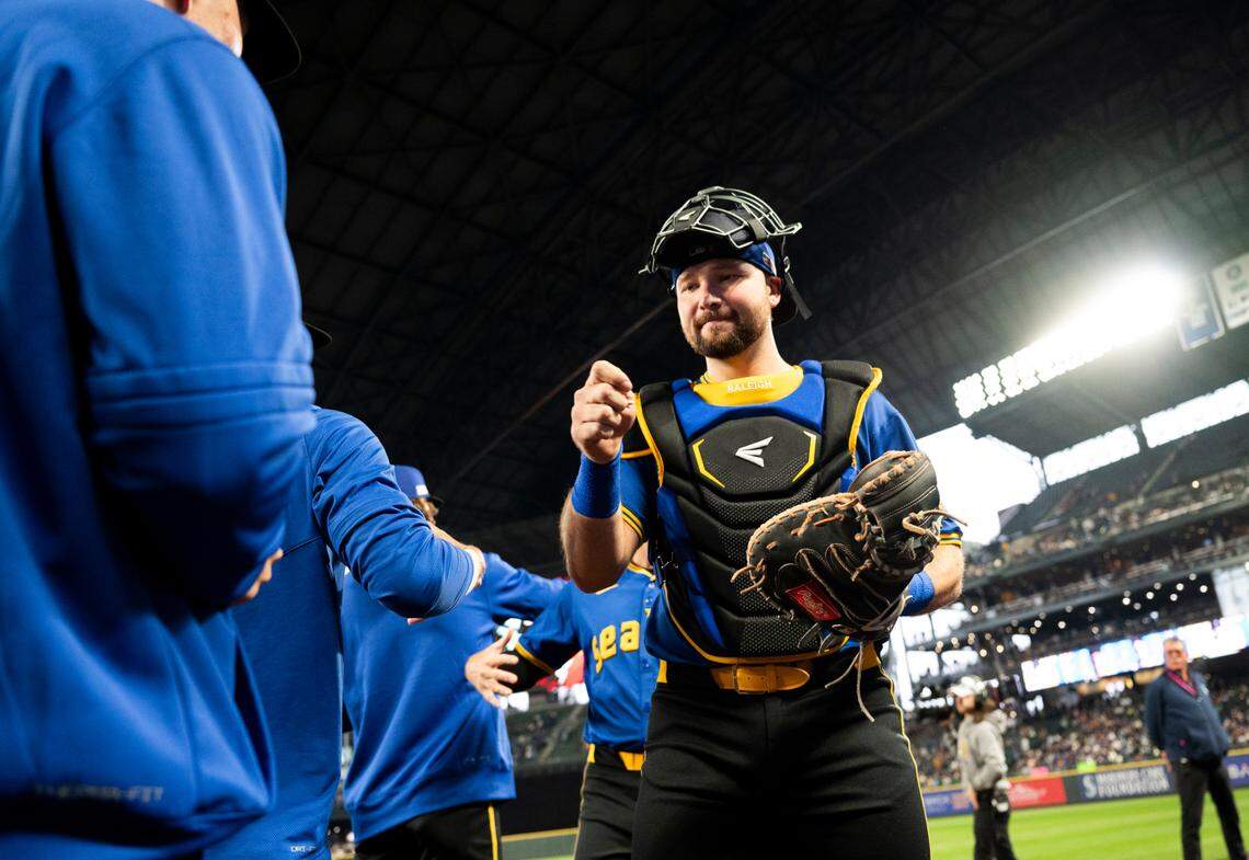 Seattle Mariners catcher Cal Raleigh (29) greets teammates before the game against the Texas Rangers at T-Mobile Park, on Friday, June 14, 2024, in Seattle, Wash.