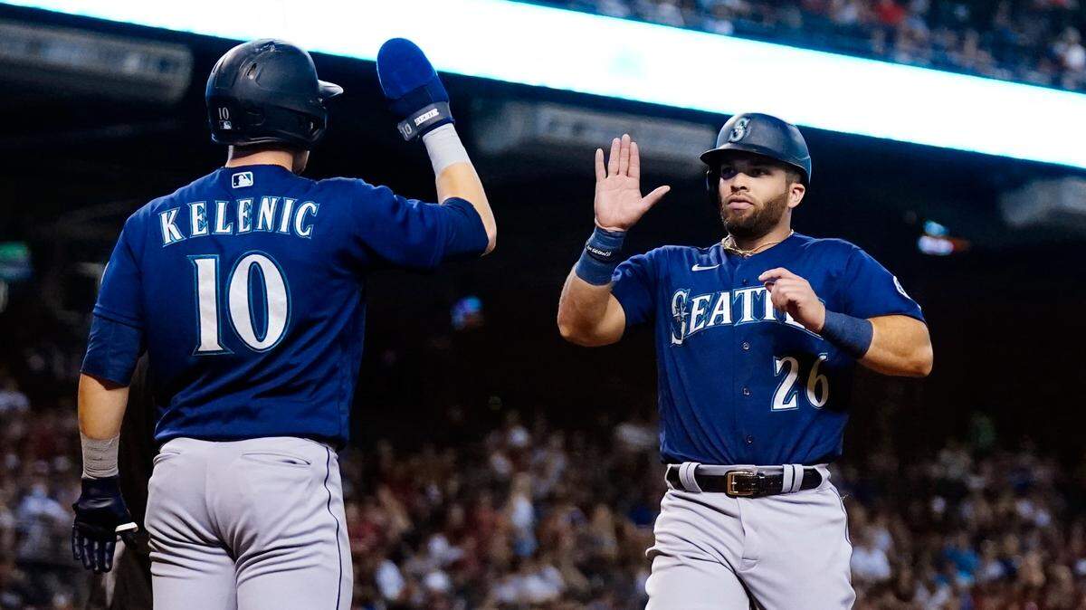Seattle Mariners’ Jose Marmolejos (26) and Jarred Kelenic (10) celebrate after both score runs against the Arizona Diamondbacks during the fourth inning of a baseball game Saturday, Sept. 4, 2021, in Phoenix. (AP Photo/Ross D. Franklin)