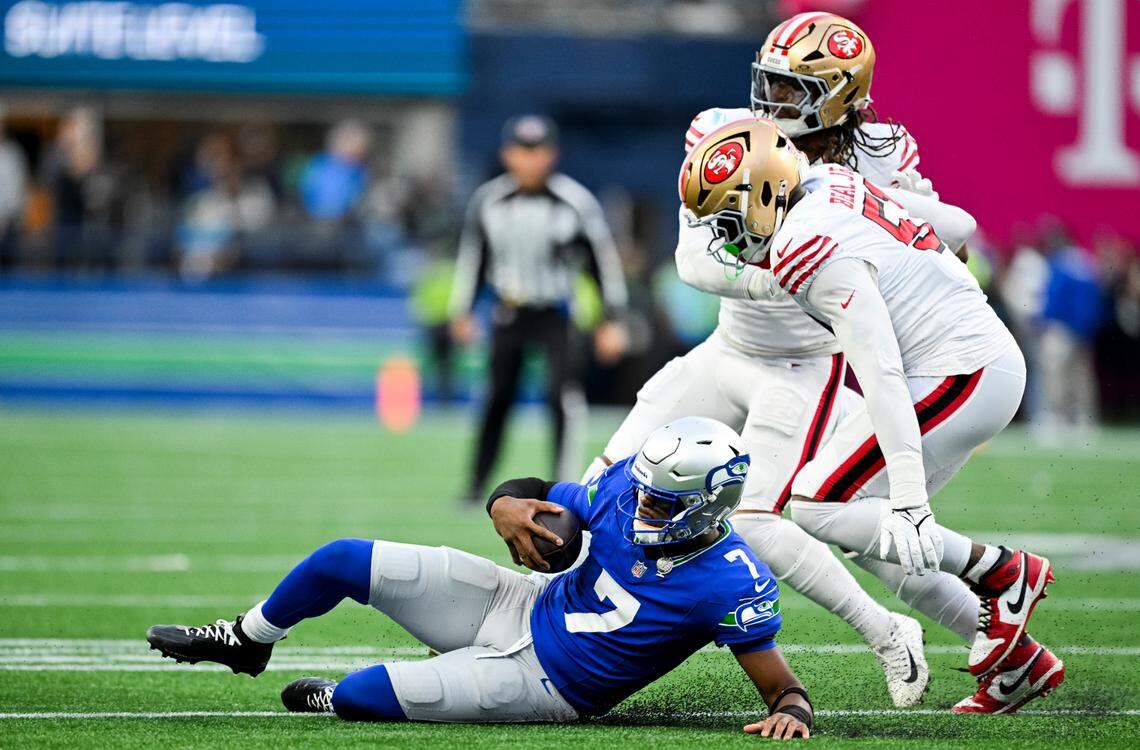 Seattle Seahawks quarterback Geno Smith (7) slides after picking up some yardage during the second quarter of the game against the San Francisco 49ers at Lumen Field, on Thursday, Oct. 10, 2024, in Seattle, Wash.