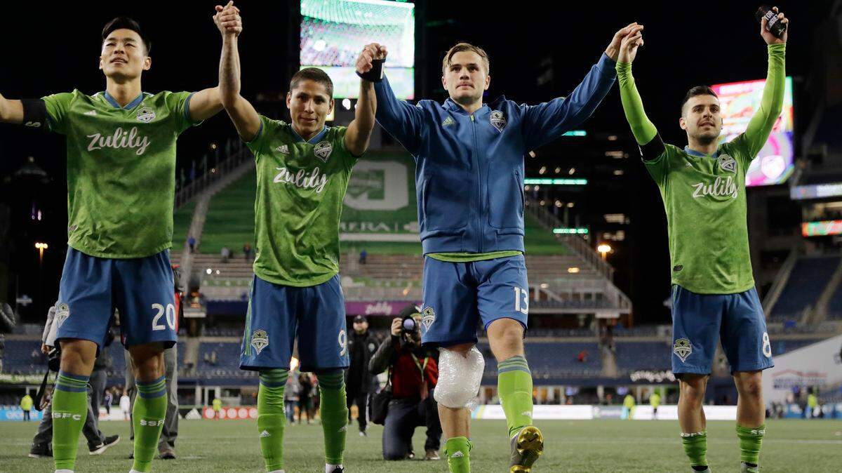 Seattle Sounders forward Jordan Morris, second from right, celebrates with teammates Kim Kee-Hee, left, Raul Ruidiaz, second from left, and Victor Rodriguez, right, after the Sounders defeated FC Cincinnati 4-1 in an MLS soccer match Saturday, March 2, 2019, in Seattle. Morris scored two goals and Ruidiaz scored one in the match. (AP Photo/Ted S. Warren)