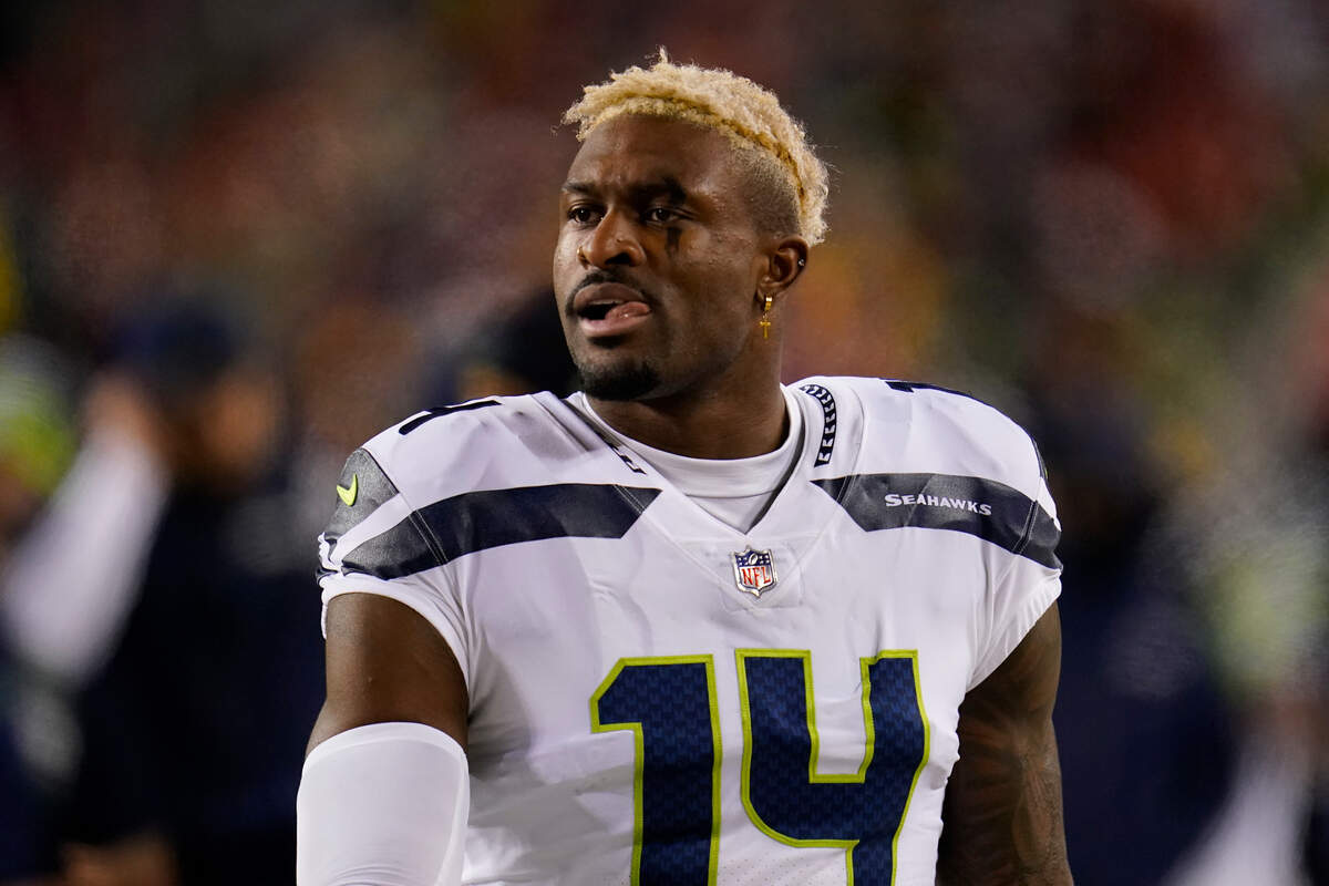 Seattle Seahawks wide receiver DK Metcalf (14) walking on the sideline during the second half of an NFL football game against the Washington Football Team, Monday, Nov. 29, 2021, in Landover, Md. (AP Photo/Julio Cortez)