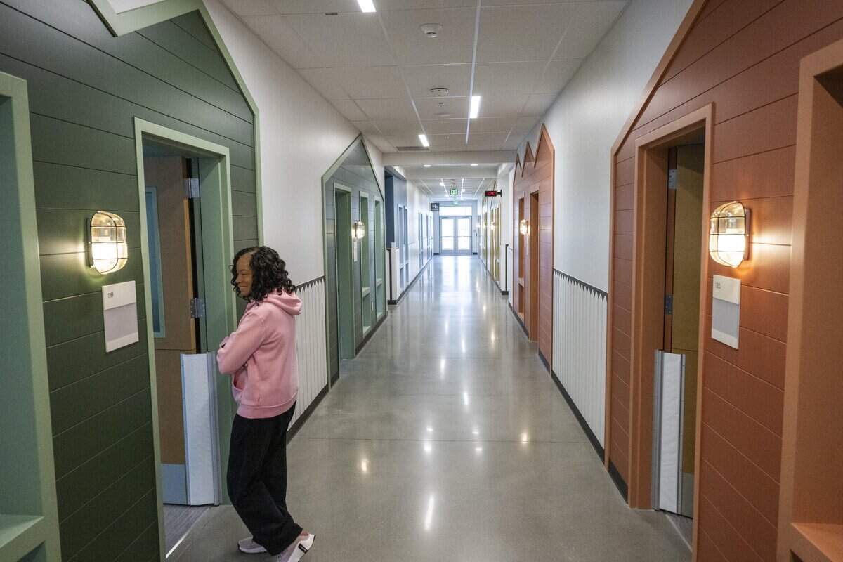Classrooms are decorated as houses, giving a neighborhood look to the hallways of the new Cora Whitley Family Center on Friday, June 26, 2026, in Tacoma, Wash. Gail Neal, executive director of the Multicultural Child and Family Hope Center, walks between rooms during a tour of the facility.