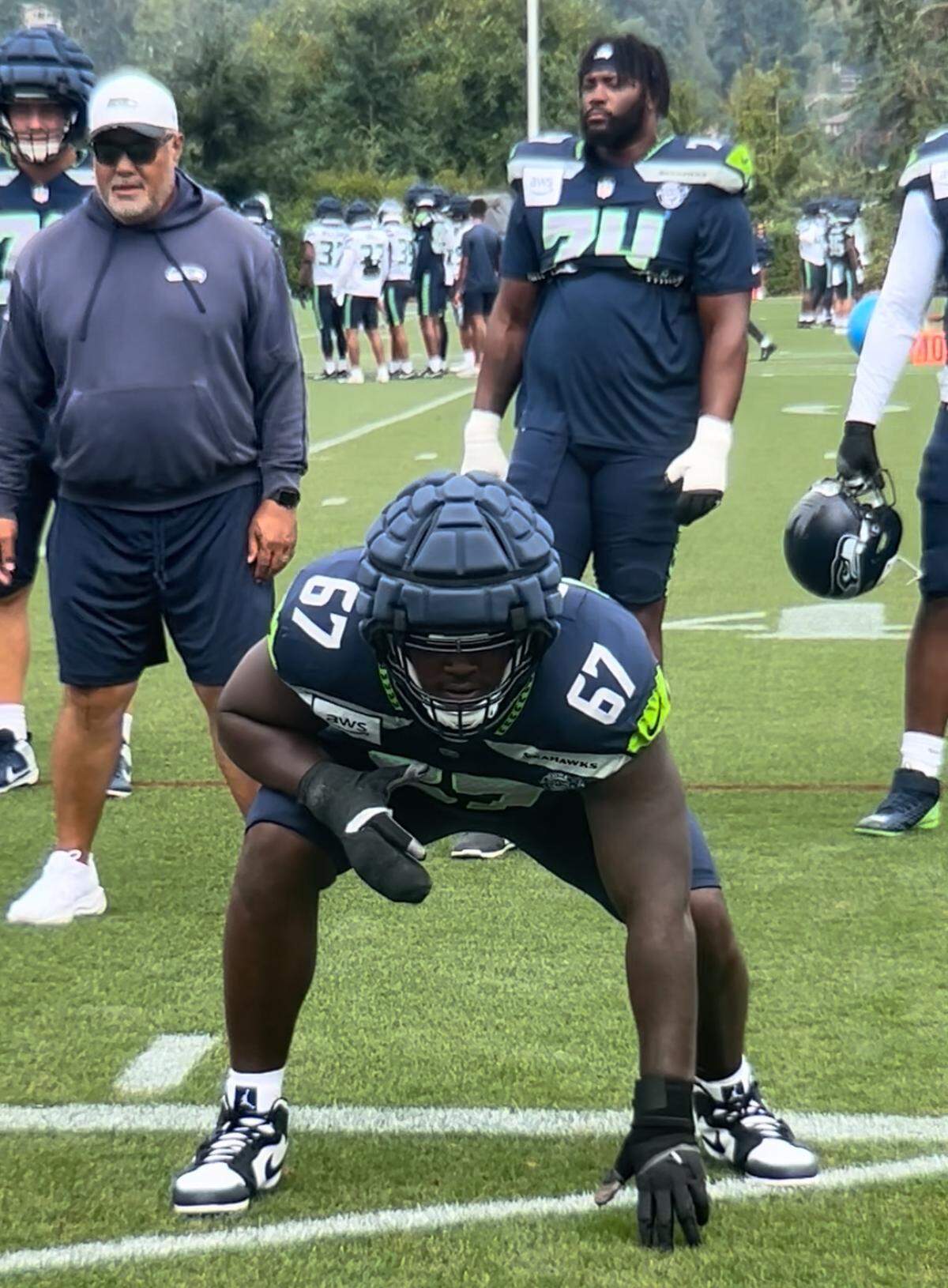 Charles Cross returned to practice at Seattle Seahawks training camp Aug. 4, 2025, less than a week after the starting left tackle had surgery for a dislocated ring finger on his right hand.