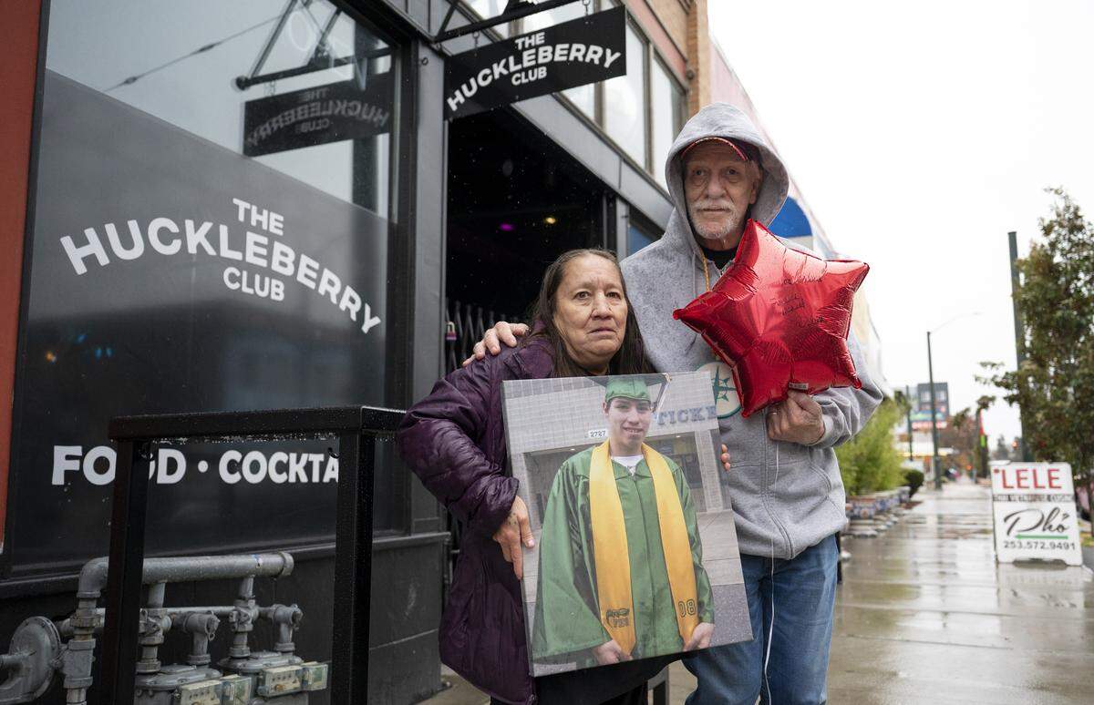 Kimberly Nystrom and Bill DeMulling, the mother and stepfather of Steven Speakman, stand in a spot along Martin Luther King Jr. Way in the Hilltop neighborhood where Speakman was fatally shot 10 years earlier. Photographed on Monday, Nov. 3, 2025, in Tacoma.