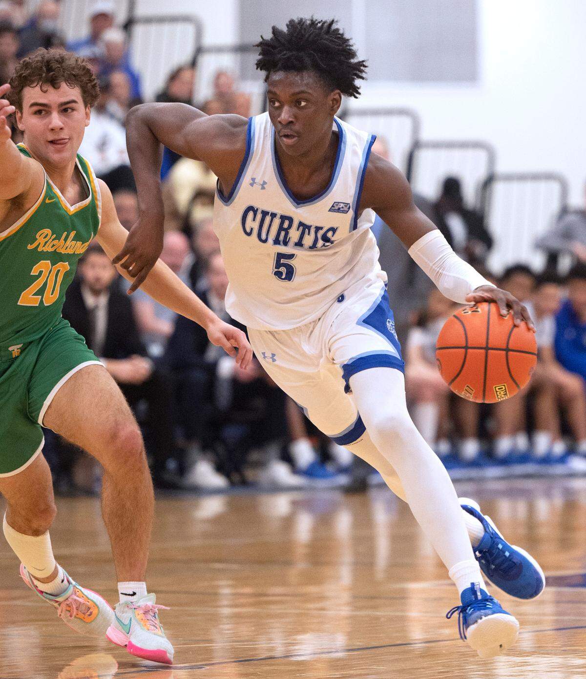 Curtis’ Zoom Diallo drives the lane against Richland defender Jase Vopalensky during Friday night’s 4A boys state regional playoff game against the Richland Bombers at Tacoma Community College in Tacoma, Washington, on Feb. 24, 2023. Curtis won the game, 64-55.