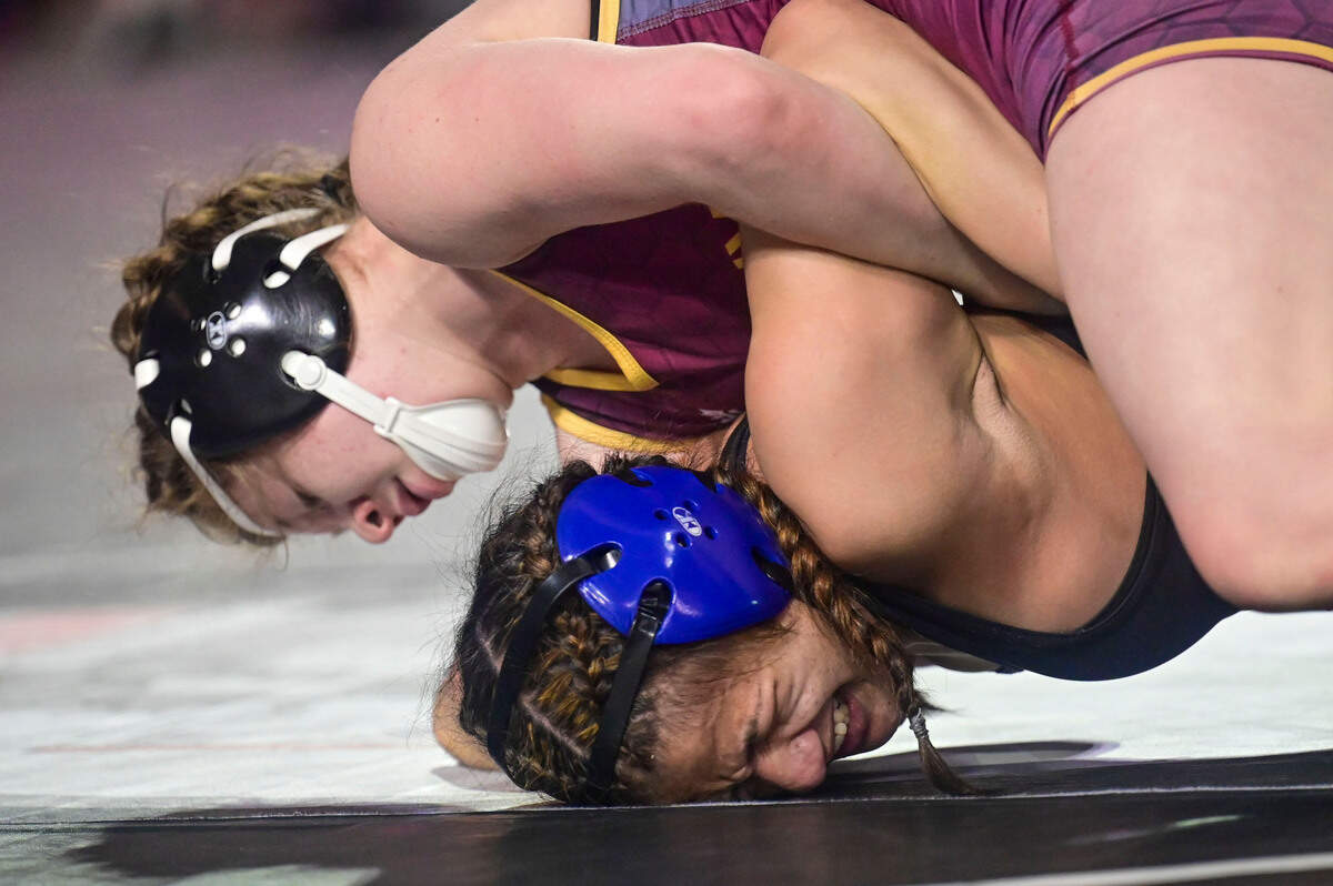 White River junior wrestler Shelby Moore attempts to flip Graham-Kapowsin’s Shelby-R Enos-Cressy on her back during the second round of their 130-pound girls quarterfinal match at Mat Classic XXXIII on Friday, Feb. 18, 2022, in Tacoma, Wash.
