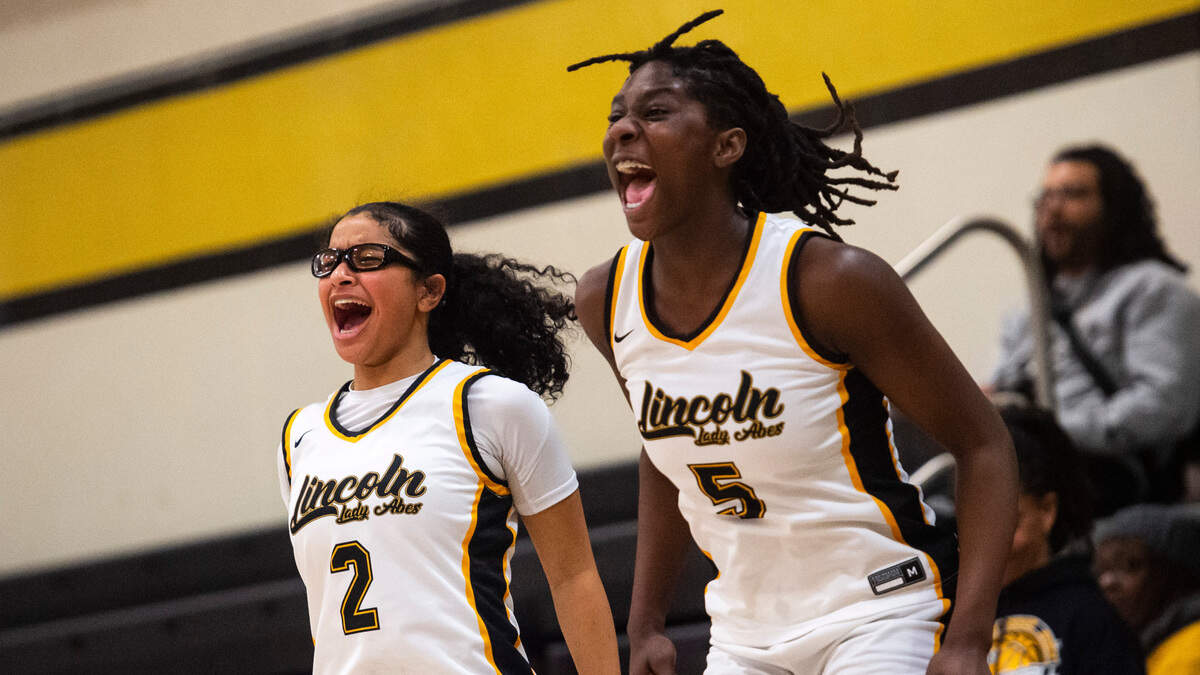 Lincoln forward Oliviyah Edwards (5) and guard Savannah So (2) cheer for their teammates from the bench during a first round Class 3A West Central/Southwest district tournament game against Todd Beamer at Lincoln High School in Tacoma, Wash. on Feb. 10, 2023. Lincoln defeated Todd Beamer 55-28.