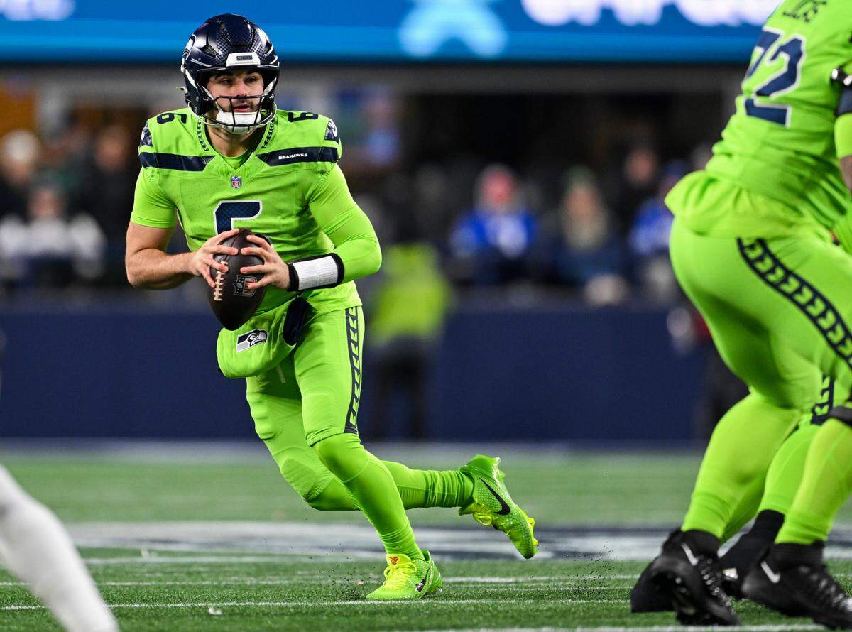 Seattle Seahawks quarterback Sam Howell (6) scrambles under pressure form Green Bay Packers during the third quarter of the game at Lumen Field, on Sunday, Dec. 15, 2024, in Seattle, Wash.