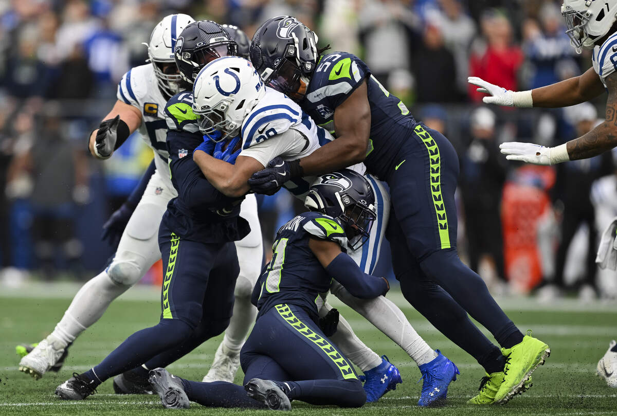 Indianapolis Colts running back Jonathan Taylor (28) runs into a wall of Seattle Seahawks defenders during the third quarter of the game at Lumen Field, on Sunday, Dec. 14, 2025, in Seattle.