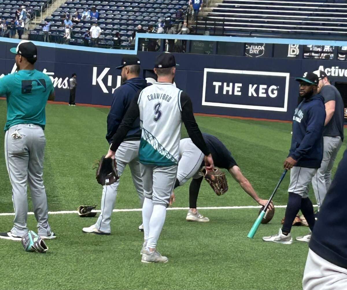 Infielder/outfielder Miles Mastrobuoni warms up before Game 2 of the American League Championship Series at Rogers Centre in Toronto wearing a basketball jersey of teammate J.P. Crawford the Mariners had as a fan giveaway for a game earlier this season.