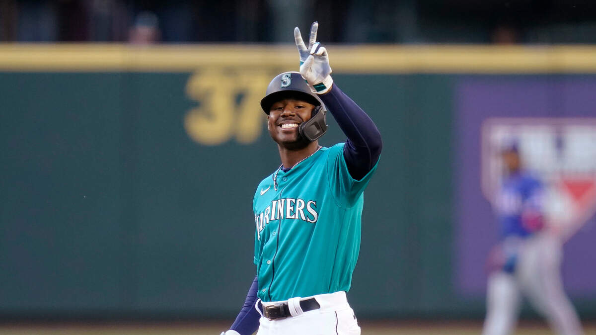 Seattle Mariners’ Kyle Lewis smiles toward the dugout and holds up two fingers as he stands on second base after a double against the Texas Rangers duringthe second inning of a baseball game Friday, May 28, 2021, in Seattle. (AP Photo/Elaine Thompson)