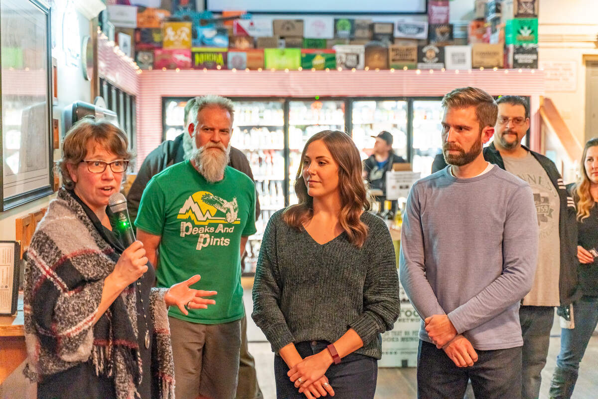 Emergency Food Network CEO Michelle Douglas, far left, speaks at the 2022 “weigh-in” party for the Hoppy Holiday Food Drive. Peaks & Pints owner Ron Swarner, second from left, joins event producers Catie and John Douville.