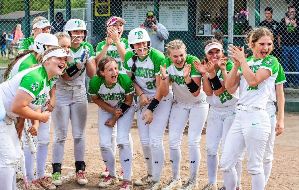 Tumwater’s softball team gathers at home plate to celebrate a home run in a win over rival Black Hills, 13-2, on senior night at Tumwater High School on May 7, 2025, in Tumwater, Wash. Courtesy: John O’Leary