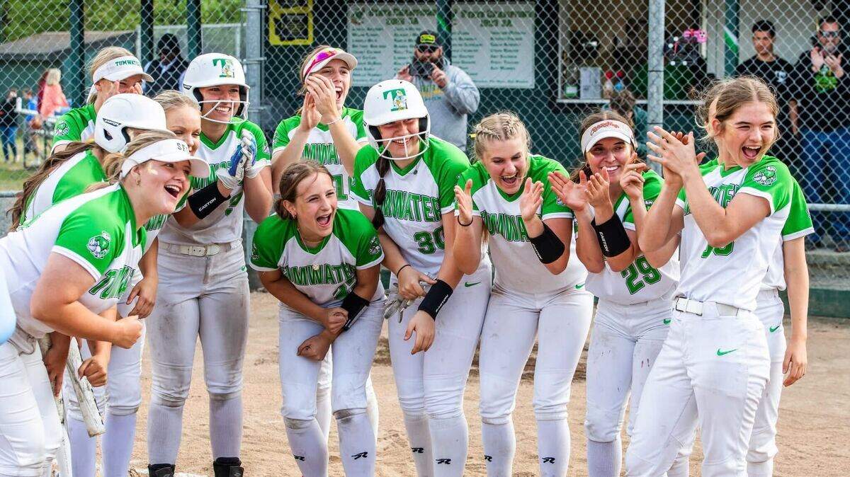 Tumwater’s softball team gathers at home plate to celebrate a home run in a win over rival Black Hills, 13-2, on senior night at Tumwater High School on May 7, 2025, in Tumwater, Wash. Courtesy: John O’Leary