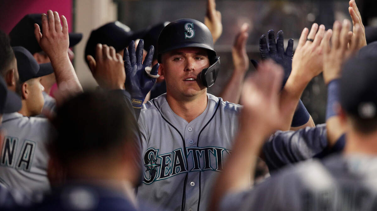Seattle Mariners’ Ryon Healy, center, is greeted by teammates after hitting a thee-run home run during the second inning of a baseball game against the Los Angeles Angels on Thursday, April 18, 2019, in Anaheim, Calif. (AP Photo/Jae C. Hong)