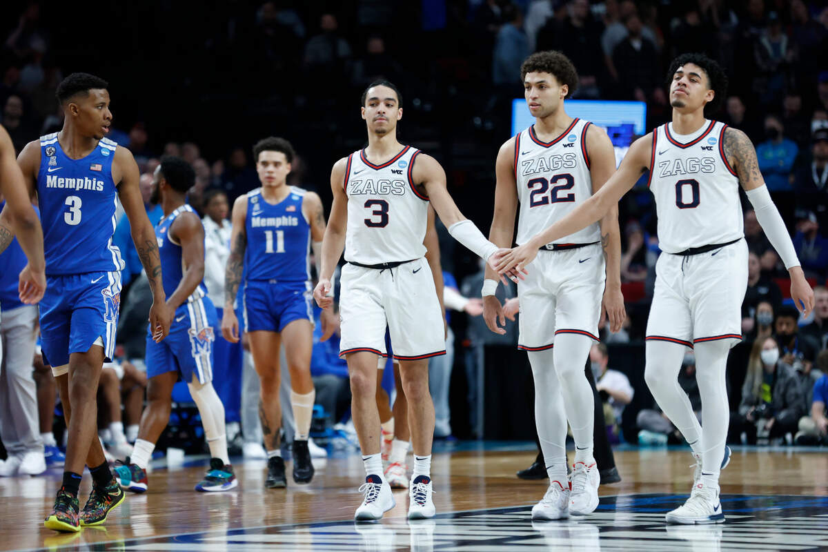Gonzaga guard Andrew Nembhard (3), forward Anton Watson (22), and guard Julian Strawther (0) react during the second half of a second-round NCAA college basketball tournament game against Memphis, Saturday, March 19, 2022, in Portland, Ore. Gonzaga won 82-78. (AP Photo/Craig Mitchelldyer)