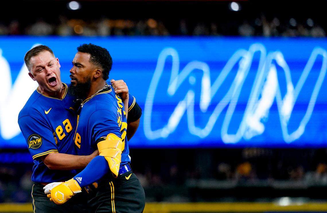Seattle Mariners’ Teoscar Hernandez, right, celebrates with relief pitcher Paul Sewald (37) after hitting a walk-off single for a 3-2 win against the Toronto Blue Jays in a baseball game, Friday, July 21, 2023, in Seattle. (AP Photo/Lindsey Wasson)