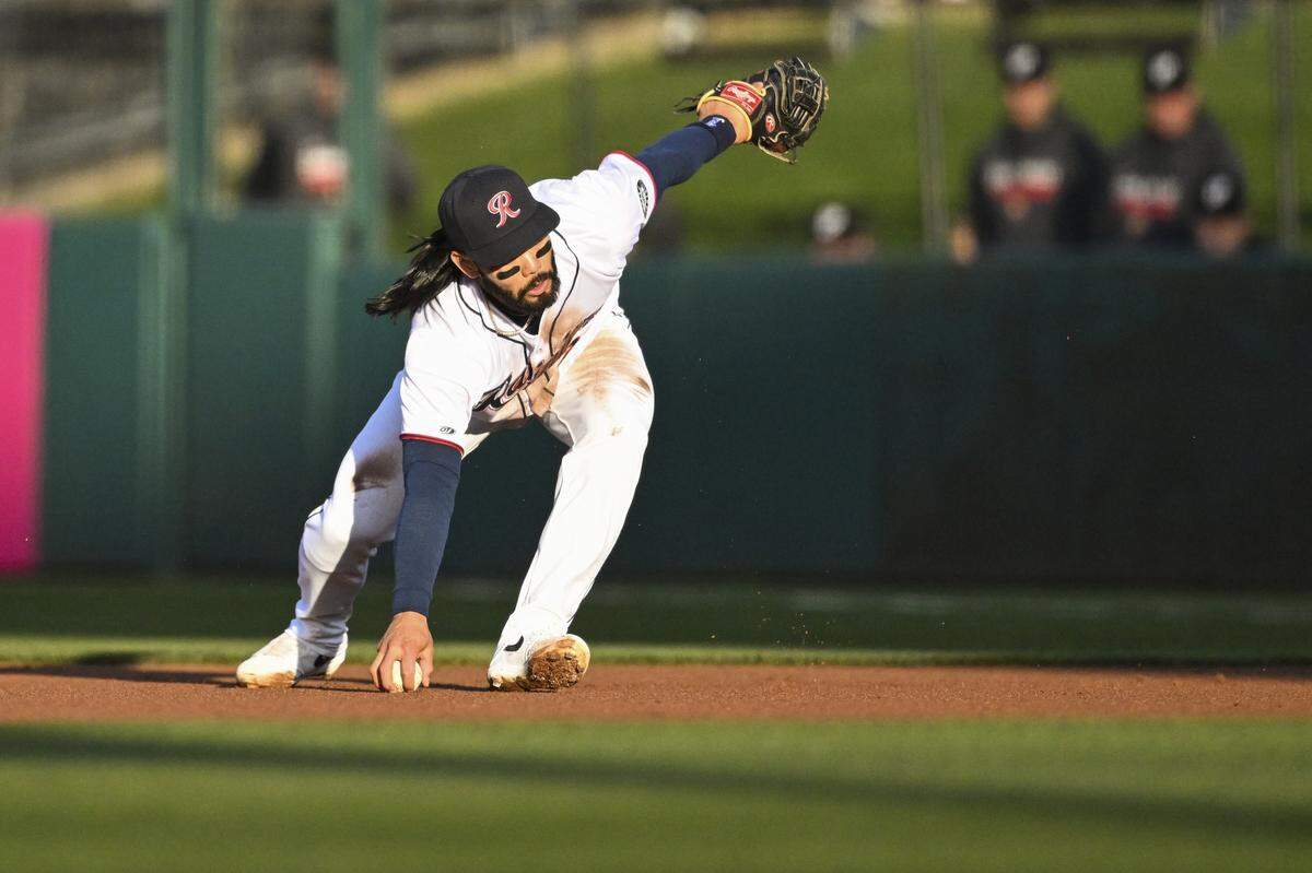 Tacoma Rainiers right fielder Connor Joe (23) reaches for the ball hit to first base by the El Paso Chihuahuas on Tuesday, March 31, 2026, at Cheney Stadium in Tacoma, Wash.