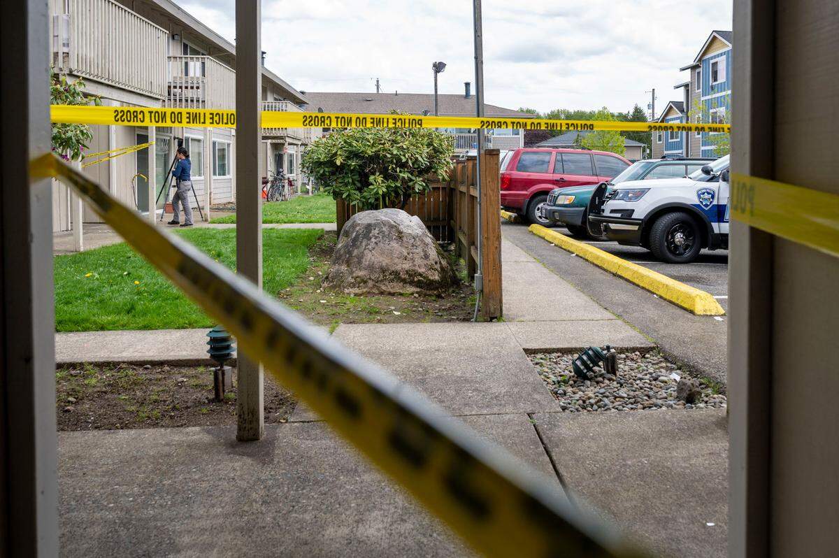 Crime scene technicians investigate the scene of a possible homicide at an apartment complex in the 7600 block of Pacific Avenue in Tacoma, Wash. on Tuesday, May 17, 2022.