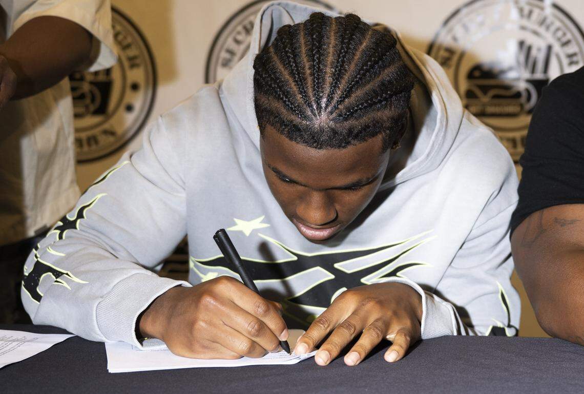 Mount Tahoma cornerback Elijah Durr signs a NIL deal with Secret Burger Kitchen, on Wednesday, Aug. 13, 2025, in Tacoma, Wash.