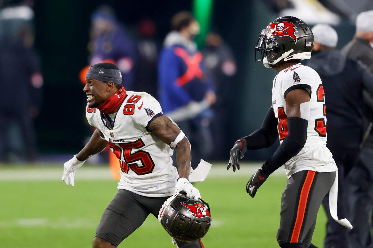 Tampa Bay Buccaneers’ Jaydon Mickens (85) reacts with Javon Hagan after winning the NFC championship NFL football game against the Green Bay Packers in Green Bay, Wis., Sunday, Jan. 24, 2021. The Buccaneers defeated the Packers 31-26 to advance to the Super Bowl. (AP Photo/Jeffrey Phelps)
