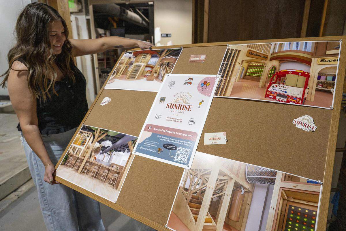 Co-owner Jordan Zenisek holds a board with images of construction plans for Sunrise Play Cafe and its custom 1,400-square-foot indoor play structure on Wednesday, Sept. 24, 2025, in Tacoma, Wash.