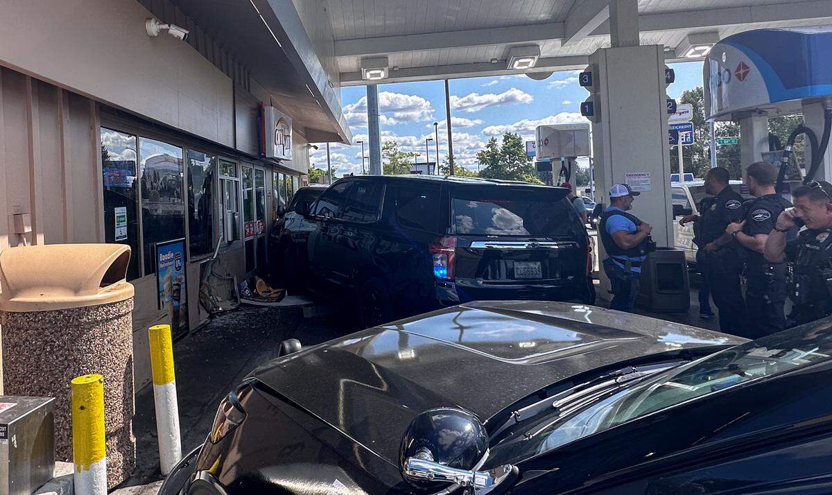 A wanted fugitive’s vehicle and a police vehicle crashed into the mini mart in Tacoma on Thursday, July 27.