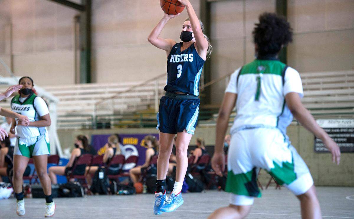 Rogers’ Allyson Pettit puts up a jumper in front of Emerald Ridge defender Promise Reams during the opening night of high school basketball on the arena courts at the Washington State Fairgrounds in Puyallup, Washington, on Wednesday, May 12, 2021. Rogers won the game, 56-46.