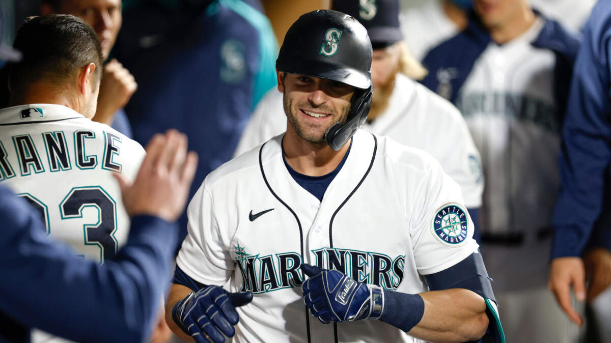 Seattle Mariners’ Mitch Haniger celebrates in the dugout after hitting a solo home run in the seventh inning of a baseball game against the Oakland Athletics Tuesday, Sept. 28, 2021, in Seattle. (AP Photo/Jason Redmond)