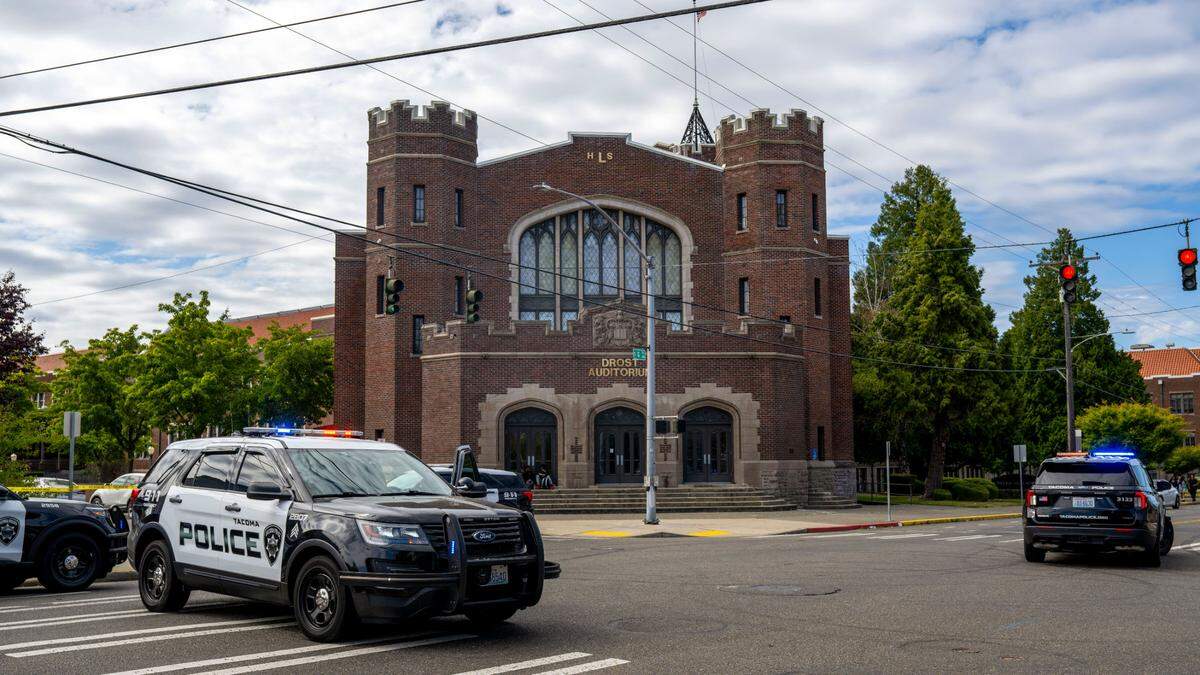 Tacoma Police block off the road in front of Lincoln High School at the intersection of South 37th Street and South G Street after a shooting on Tuesday, June 17, 2025, in Tacoma, Wash.