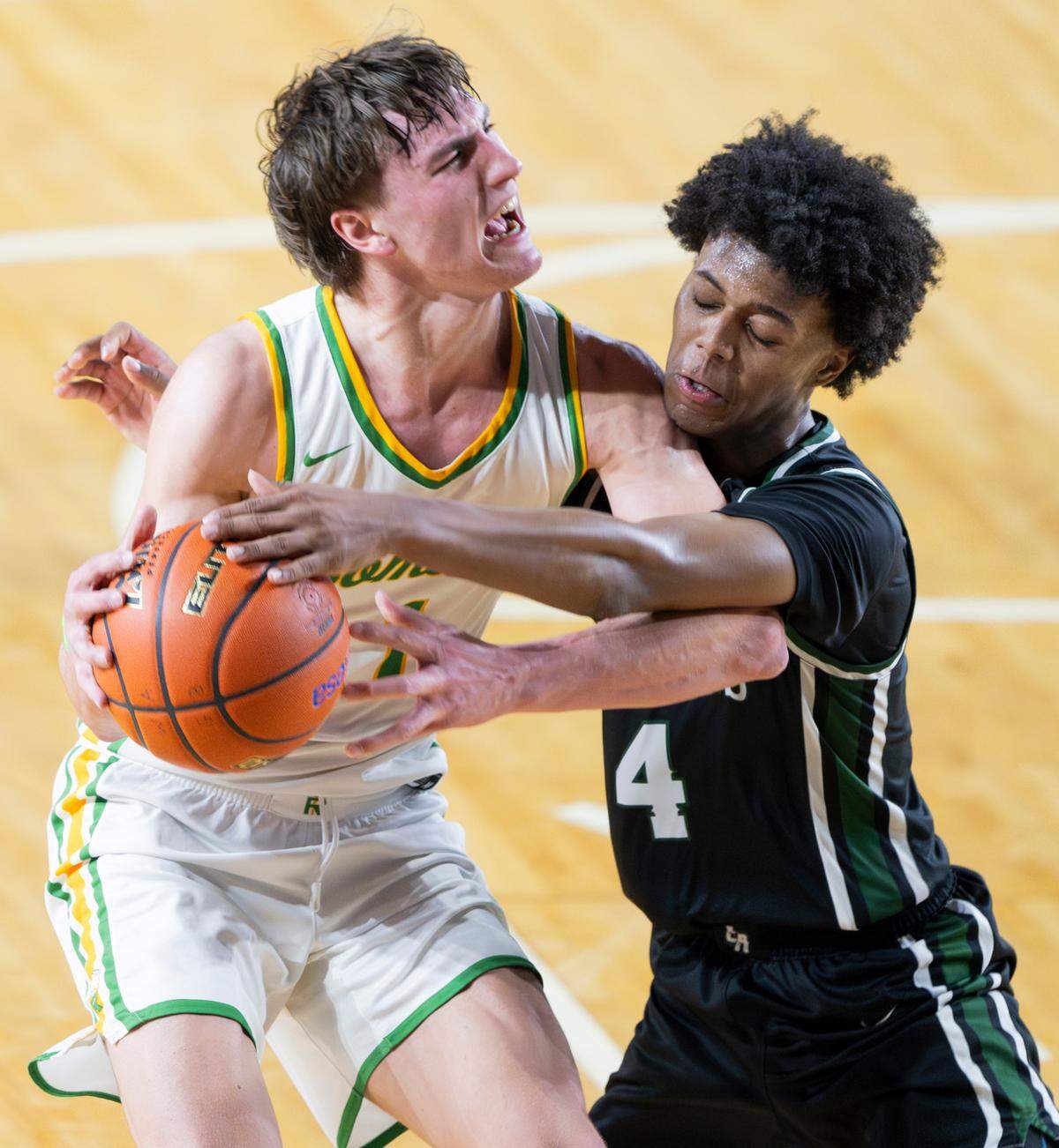 Richland’s Landon Northrop (1) is fouled by Emerald Ridge’s Jordan Bennett (4) during the second half of a Class 4A state basketball tournament first-round game at the Tacoma Dome on Wednesday, March 5, 2025, in Tacoma, Wash.