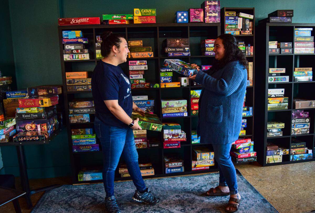 Sisters Rebekah (left) and Hannah Waltmann have already amassed a collection of more than 320 games. A small fee, which includes a drink, will give you access to table play with no time limit.