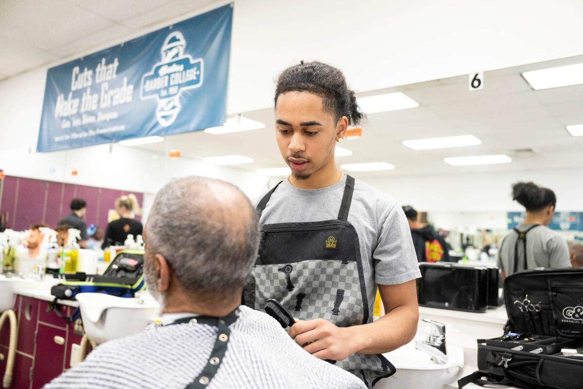 Phoenix Shepard, 18, gives client Jorge Martinez a shave at Bates Barber Shop, part of the Bates Technical College barber program, on Tuesday, April 23, 2024, in Tacoma, Wash.