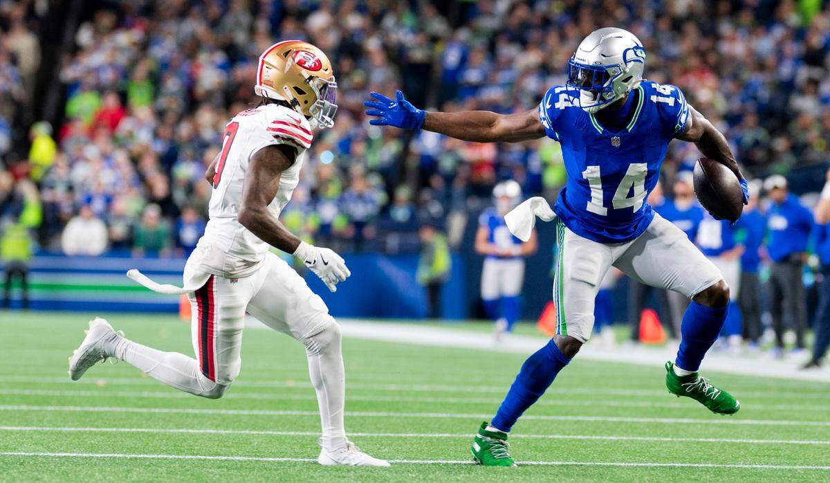 Seattle Seahawks wide receiver DK Metcalf (14) picks up yards after the catch against San Francisco 49ers cornerback Renardo Green (0) during the third quarter of the game at Lumen Field, on Thursday, Oct. 10, 2024, in Seattle, Wash.
