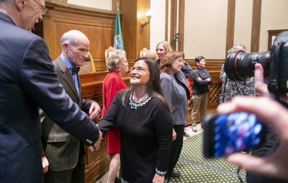 Whatcom County Superior Court Judge Raquel Montoya-Lewis greets her fellow Washington State Supreme Court justices following her appointment by Governor Jay Inslee in the Temple of Justice on the Capitol Campus in Olympia on Dec. 4.