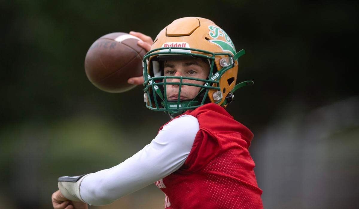 Tumwater quarterback Jaxon Budd runs through drills during preseason football practice at Tumwater District Stadium in Tumwater, Washington, on Thursday, Aug. 22, 2024.