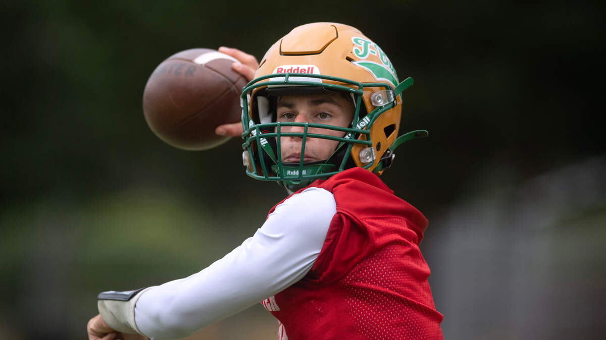 Tumwater quarterback Jaxon Budd runs through drills during preseason football practice at Tumwater District Stadium in Tumwater, Washington, on Thursday, Aug. 22, 2024.